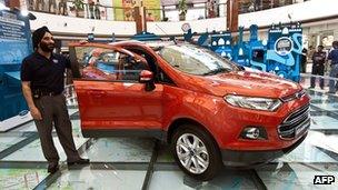 President and Managing Director of Ford India, Joginder Singh, poses with a Ford Ecosport