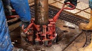 Engineers work on drilling platform at fracking facility