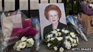 Flowers and mementos left by members of the public and admirers sit outside the home of former British Prime Minister Margaret Thatcher