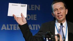 Bernd Lucke, co-founder of the Alternative for Germany, holds up a ballot paper as he addresses delegates during the first party congress in Berlin on 14 April.