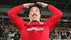 Cardiff City owner Vincent Tan does the club celebration, the "Ayatollah"