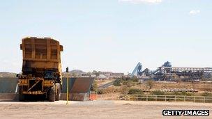 large mine truck dumps a load of coal onto a conveyer belt, in Moatize in northern Mozambique