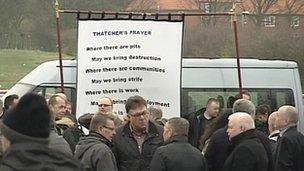 Banner entitled Thatcher's Prayer in crowd