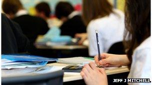 Close up pupil hand in classroom