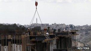 The West Bank town of Bethlehem is seen in the background as Palestinian labourers work on a construction site at a Jewish settlement near Jerusalem known to Israelis as Har Homa and to Palestinians as Jabal Abu Ghneim