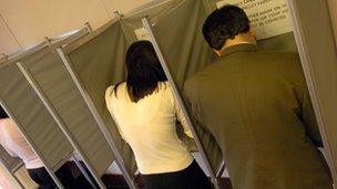 Voters in booths at polling station