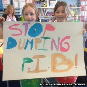 Schoolchildren with "Stop dumping PIB" poster