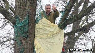 Protester in tree