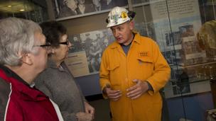 A miner guide with visitors at Big Pit Mining Museum, 2012