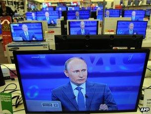 Vladimir Putin's face on TV screens in a Moscow shop, 25 April