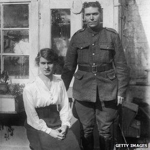 A British soldier and his wife posing for a portrait in their back yard, circa 1915