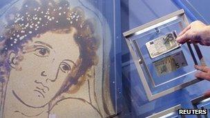 A portrait of Europa is seen next to new and old five-euro notes in Frankfurt, 10 January