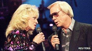 Country singer George Jones (R) is pictured with the late Tammy Wynette at the Country Music Association Awards in Nashville, Tennessee 4 October 1995