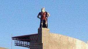 mascot on top of a football stadium