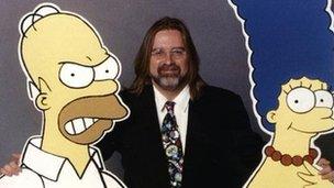 Matt Groening with cut-outs of Homer and Marge Simpson in 1996