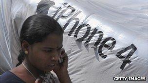 Indian woman in front of iPhone 4 logo in Hyderabad