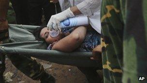 A Bangladeshi woman who has been pulled alive from the rubble in Savar, near Dhaka. Photo: 26 April 2013