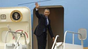 President Barack Obama waves as he boards Air Force One