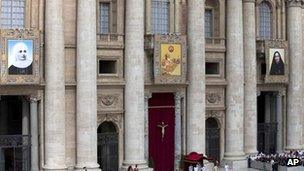 Tapestries (from the left) showing Laura di Santa Caterina da Siena Montoya of Colombia, Antonio Primaldo and his companions, also known as the Martyrs of Otranto, and Maria Guadalupe Garcia Zavala of Mexico hang from balconies in St Peter's Square at the Vatican