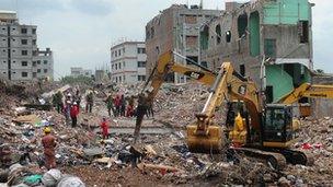 Bangladeshi Army personel stand as they continue the second phase of the rescue operation