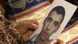 A Tunisian mother holds a photograph of the son who has joined the rebels to fight in Syria