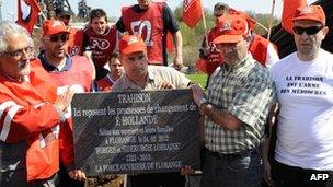 Unionists and employees of steel giant ArcelorMittal's blast furnaces at Florange, eastern France, carry a mock tombstone bearing the legend: "Betrayal - Here lie the broken promises of F Hollande"