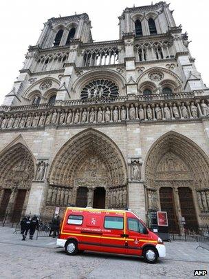 Police and a fire brigade vehicle stand outside Notre dame Cathedral in Paris, 21 May