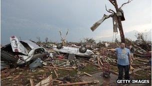 Local resident shows the cars that were destroyed