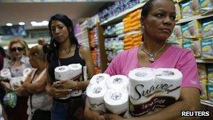 Women queuing to pay for toilet paper at a supermarket in Caracas