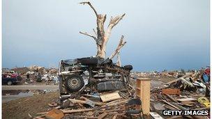 A pickup truck is wrapped around a tree in Moore, Oklahoma