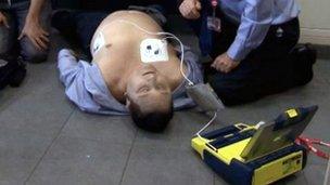 Employees during a training exercise on how to use an automatic electronic defibrillator (AED)