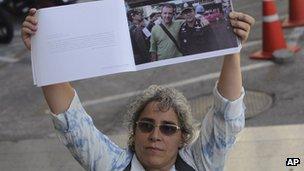 Elisabetta Polenghi, younger sister of Italian photographer Fabio Polenghi, shows his photo book at the South Criminal Court in Bangkok, Thailand, 29 May 2013