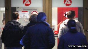 People wait in front of the unemployment agency in Wuppertal, Germany