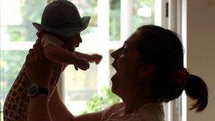 Mother and baby in silhouette file picture