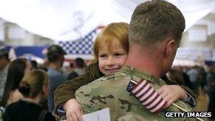 Child hugs Master Sergeant Adam Shaw