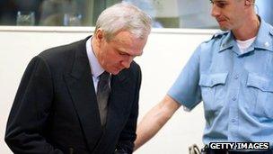 Jovica Stanisic takes his seat during his initial appearance at International Criminal Tribunal for the former Yugoslavia in June 2003.