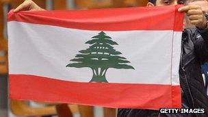 Man waves Lebanese flag