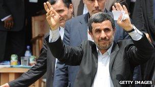 Mahmoud Ahmadinejad waves as he arrives in Accra, Ghana