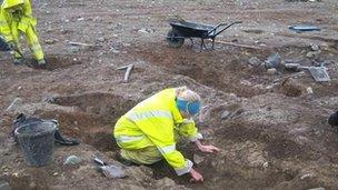 archaeologists at the site