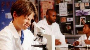 Pupil looking into a microscope