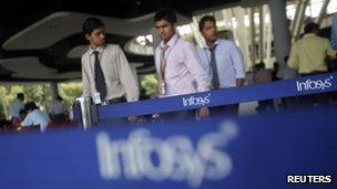 Employees of Indian software company Infosys walk past the company"s logos at their campus in the Electronic City area in Bangalore in this September 4, 2012 file phot