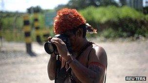 An indigenous Brazilian with a camera at a protest against the Belo Monte dam on 6 May 2013