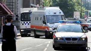 Police vans believed to be carrying the six men