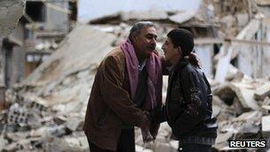 Men greet each other in Douma, Damascus