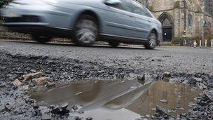 Car passing pothole