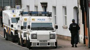 Police vehicles line a street in Enniskillen ahead of the summit