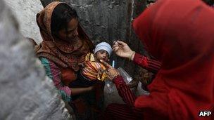 Polio workers are regularly targeted in Pakistan - file shot of child being vaccinated