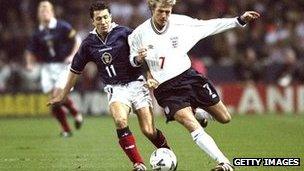 John Collins and David Beckham battle for the ball in 1999