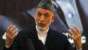 Afghan President Hamid Karzai speaks during a news conference, 18 June