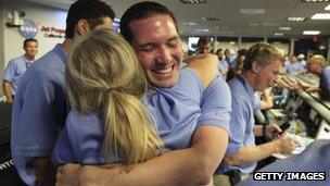 NASA colleagues hugging and cheering